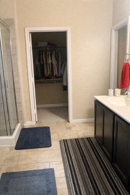 11613 Reading Court Austin, TX 78717 - Photo 11 of 16 a living room with a bed and a walk in closet