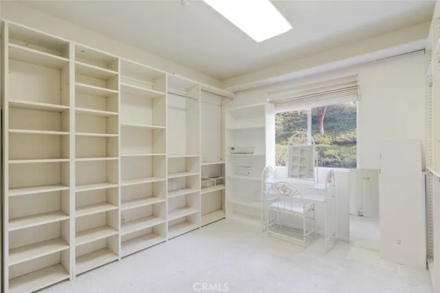 a bed sitting in a room next to a window