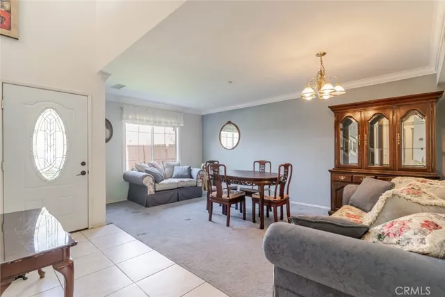 a dining room with furniture a chandelier and window