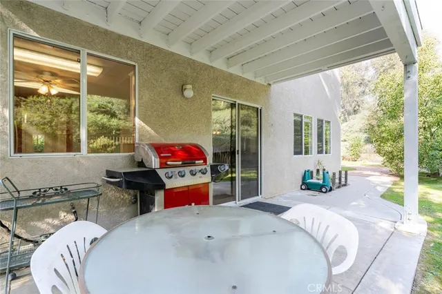 a view of a house with backyard and sitting area