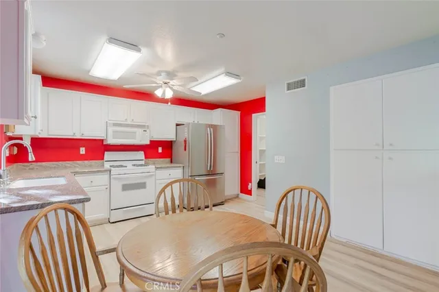 a kitchen with stainless steel appliances granite countertop a sink and dishwasher a stove with wooden floor