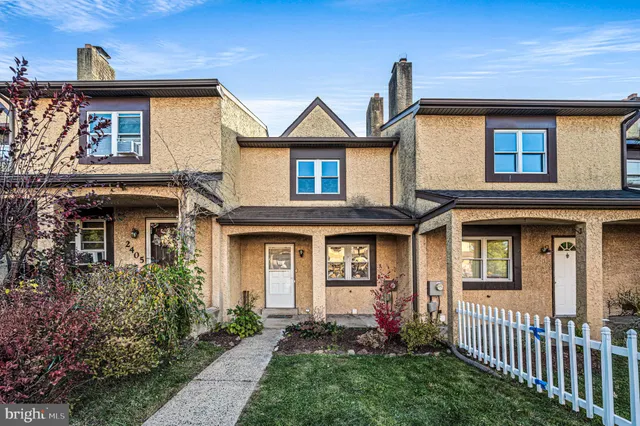 a front view of a house with yard and porch