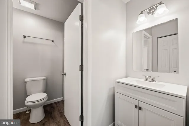 a bathroom with a sink a toilet and shower curtain