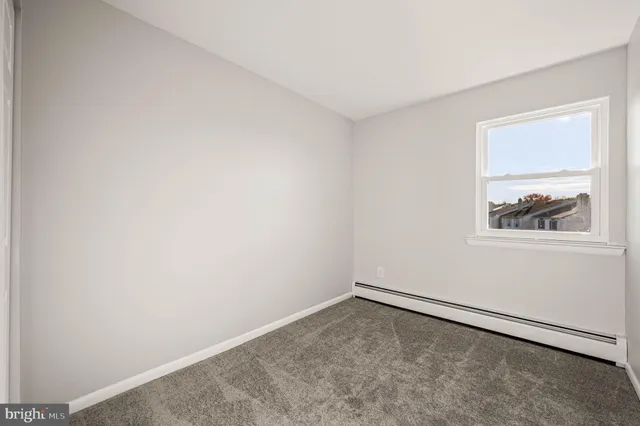 a view of a room with a large window and bathroom view