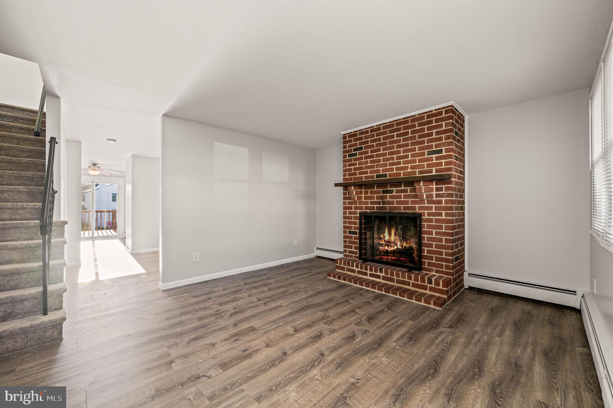 2404 Walnut Ridge Drive Pottstown, PA 19464 - Photo 3 of 24 a view of an empty room with wooden floor a fireplace and a window