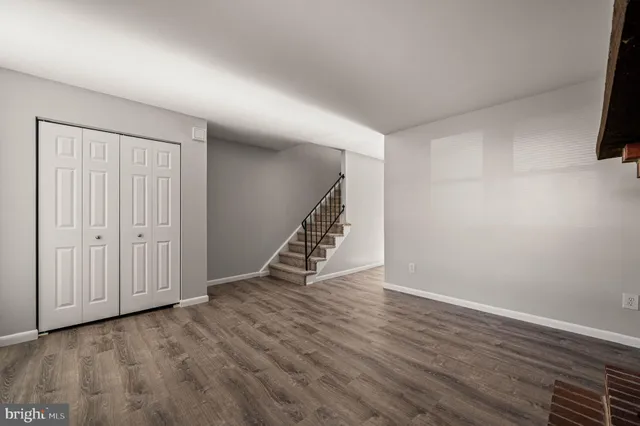 a view of a room with wooden floor and white walls
