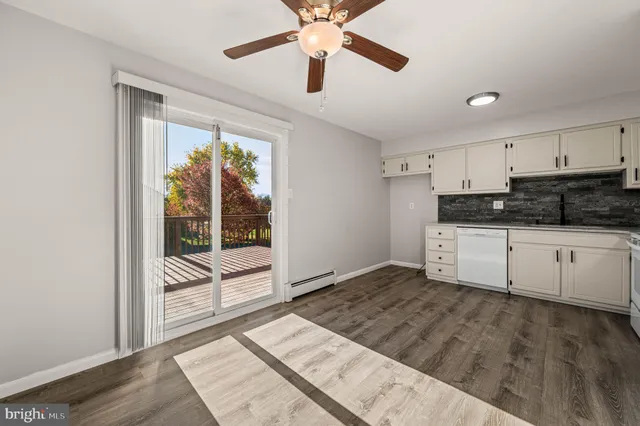 a white kitchen with granite countertop white cabinets and white appliances