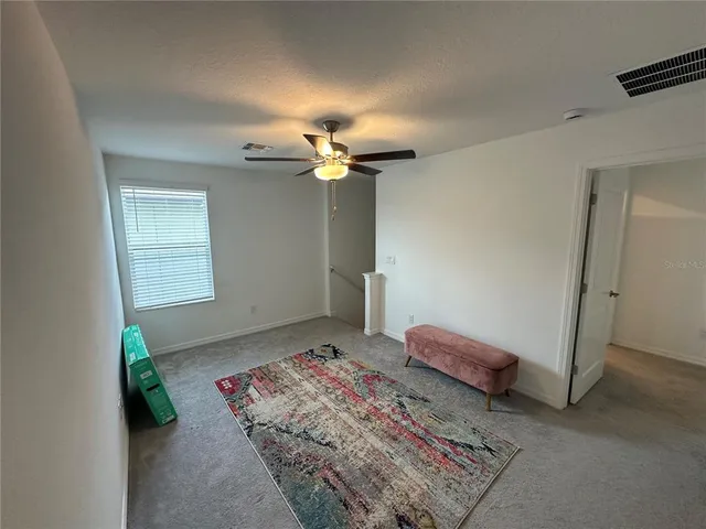 a bedroom with bed and a window