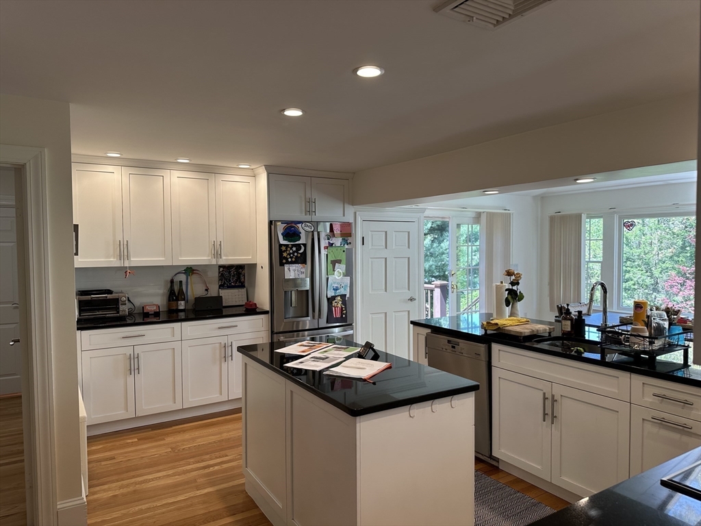 45 Wellesley Road Belmont, MA 02478 - Photo 9 of 39 a kitchen with granite countertop a sink stove and cabinets