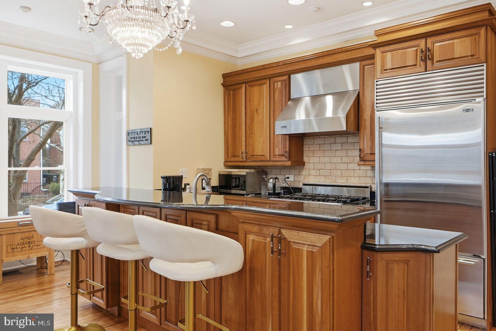 949 S Street Northwest Washington, DC 20001 - Photo 5 of 42 a kitchen with sink refrigerator dining table and chairs
