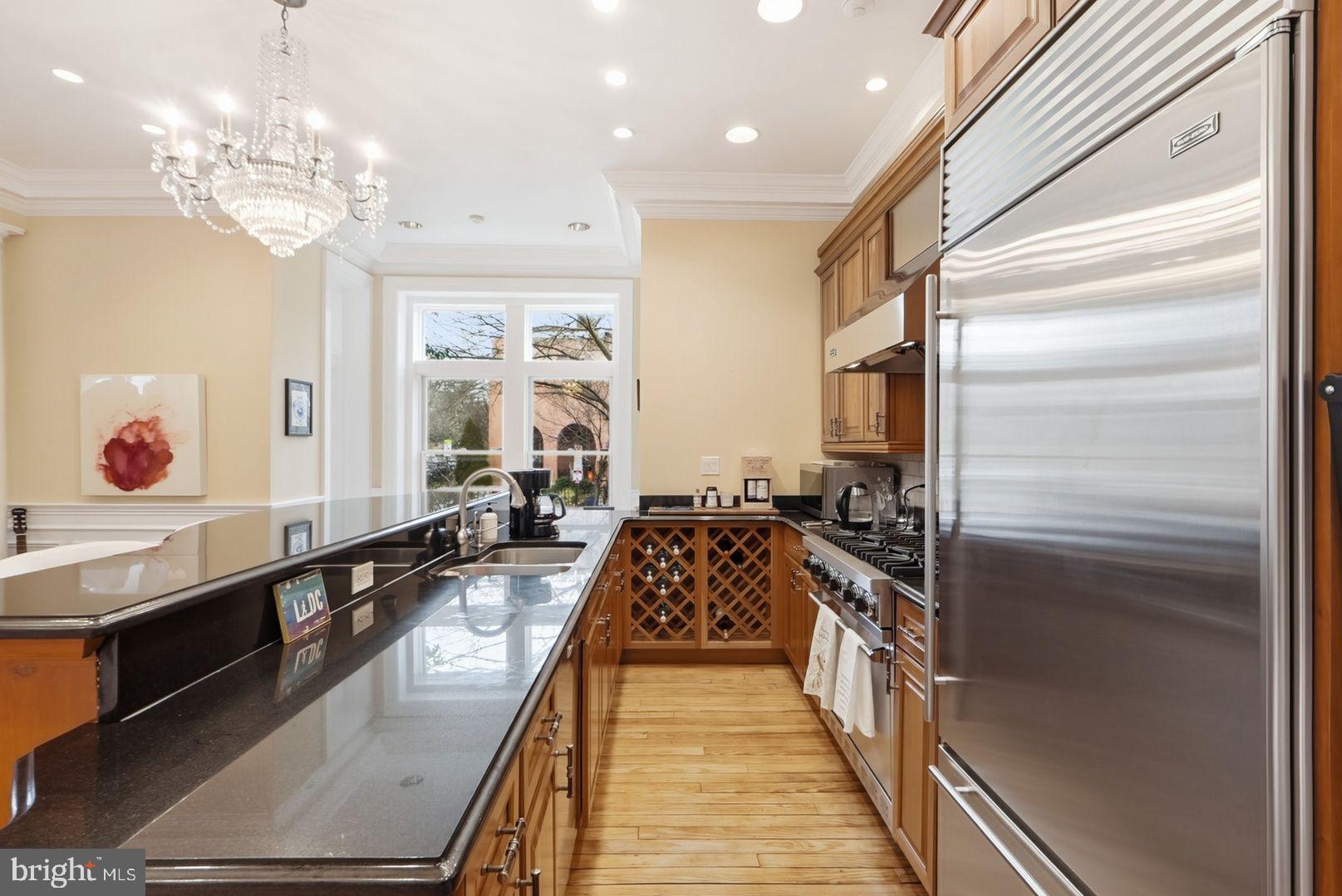 949 S Street Northwest Washington, DC 20001 - Photo 7 of 42 a large kitchen with kitchen island granite countertop a large counter top space appliances and cabinets