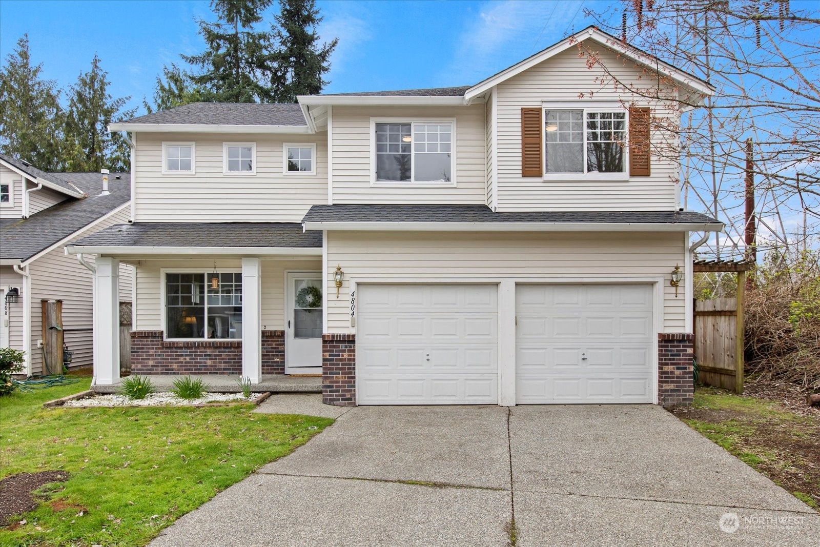 a view of a house with a yard and garage