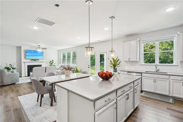 a kitchen with a sink a counter and chairs