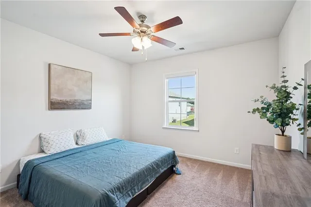 a bedroom with a bed and a potted plant