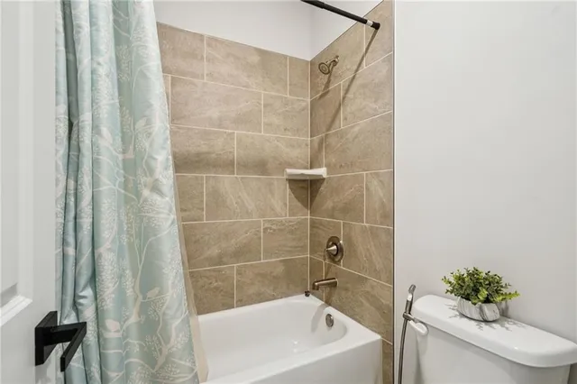 a bath tub sitting next to a white toilet