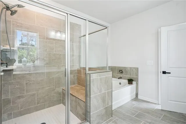 a bathroom with a bathtub and shower