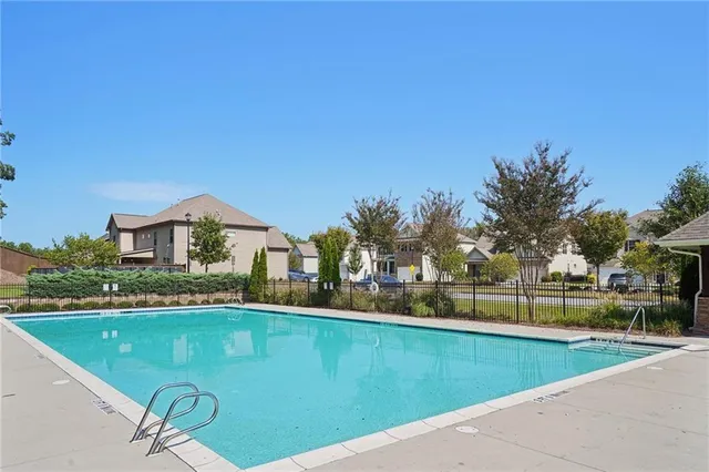 a view of a swimming pool with a house