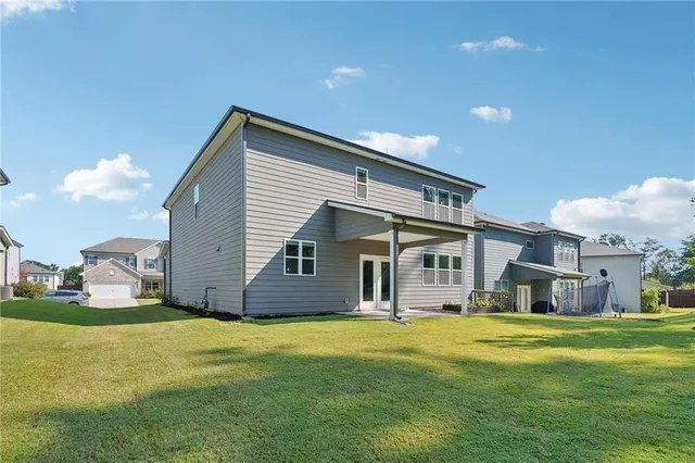 a front view of house with yard and swimming pool