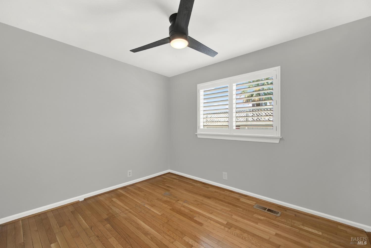 1270 Willow Lake Road Discovery Bay, CA 94505 - Photo 20 of 29 a view of an empty room with wooden floor and a window