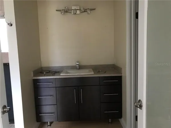 a bathroom with a sink and vanity