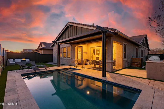 a view of a house with pool and sitting area