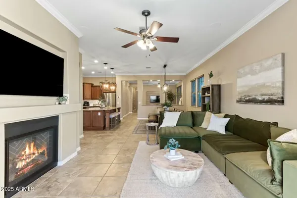 a living room with furniture a fireplace and a flat screen tv