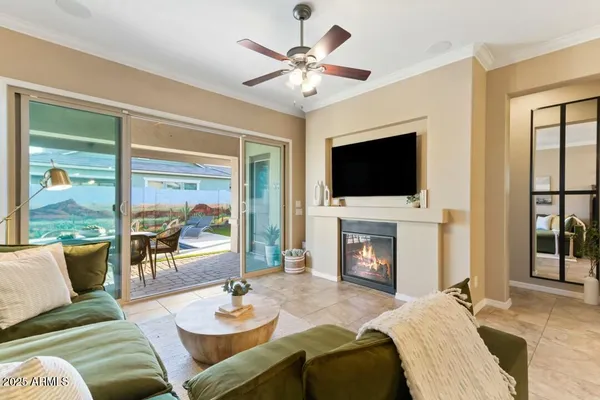 a living room with furniture a fireplace and a flat screen tv