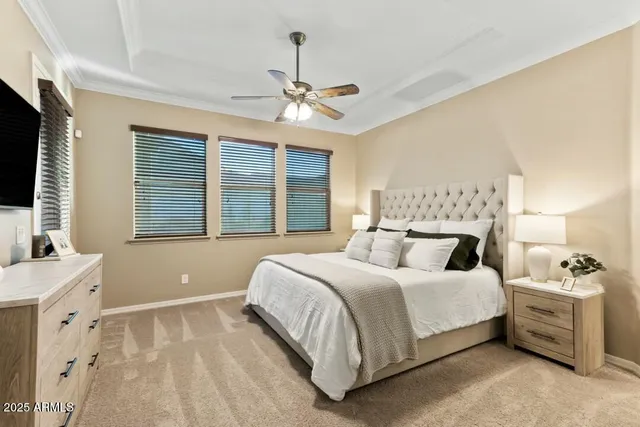a bedroom with a large bed and a chandelier