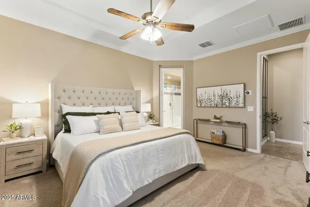 a bedroom with a bed and a chandelier