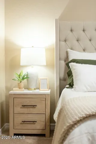 a bedroom with a bed and a potted plant