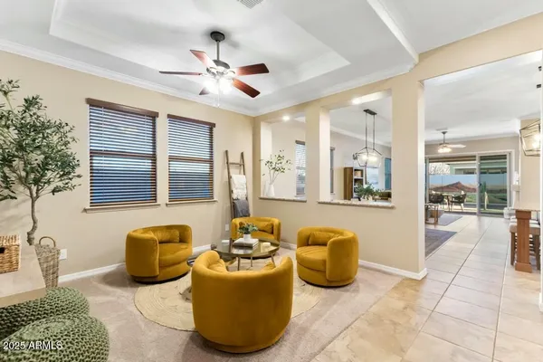 a living room with furniture a chandelier and fireplace