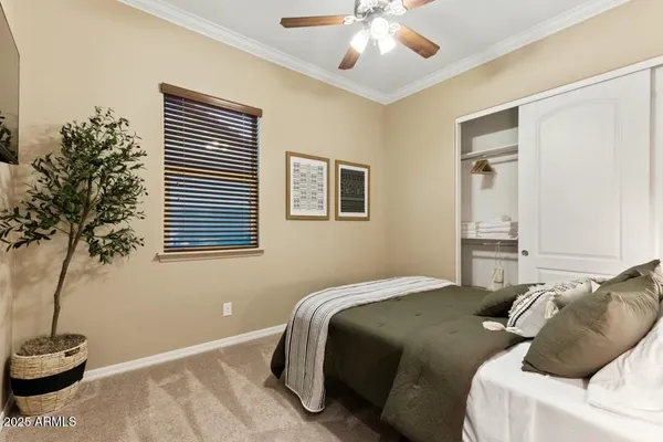 a bedroom with a bed and a potted plant