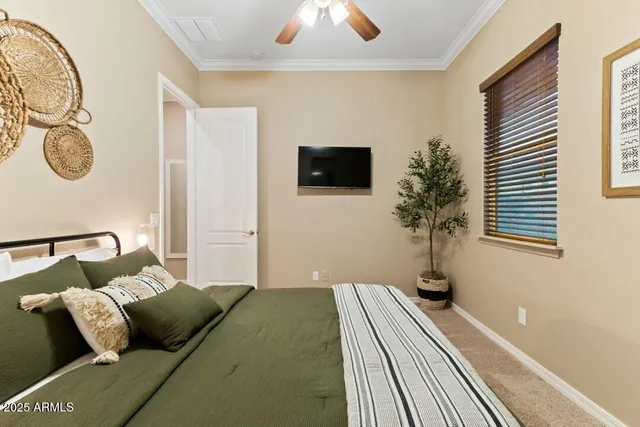 a bedroom with a bed and flat screen tv