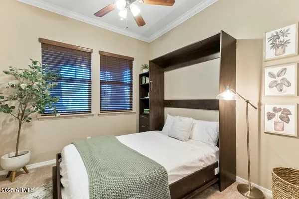 a bedroom with a bed and a chandelier