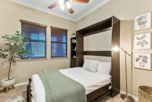 a bedroom with a bed and a chandelier