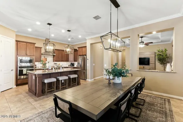a large kitchen with a table and chairs