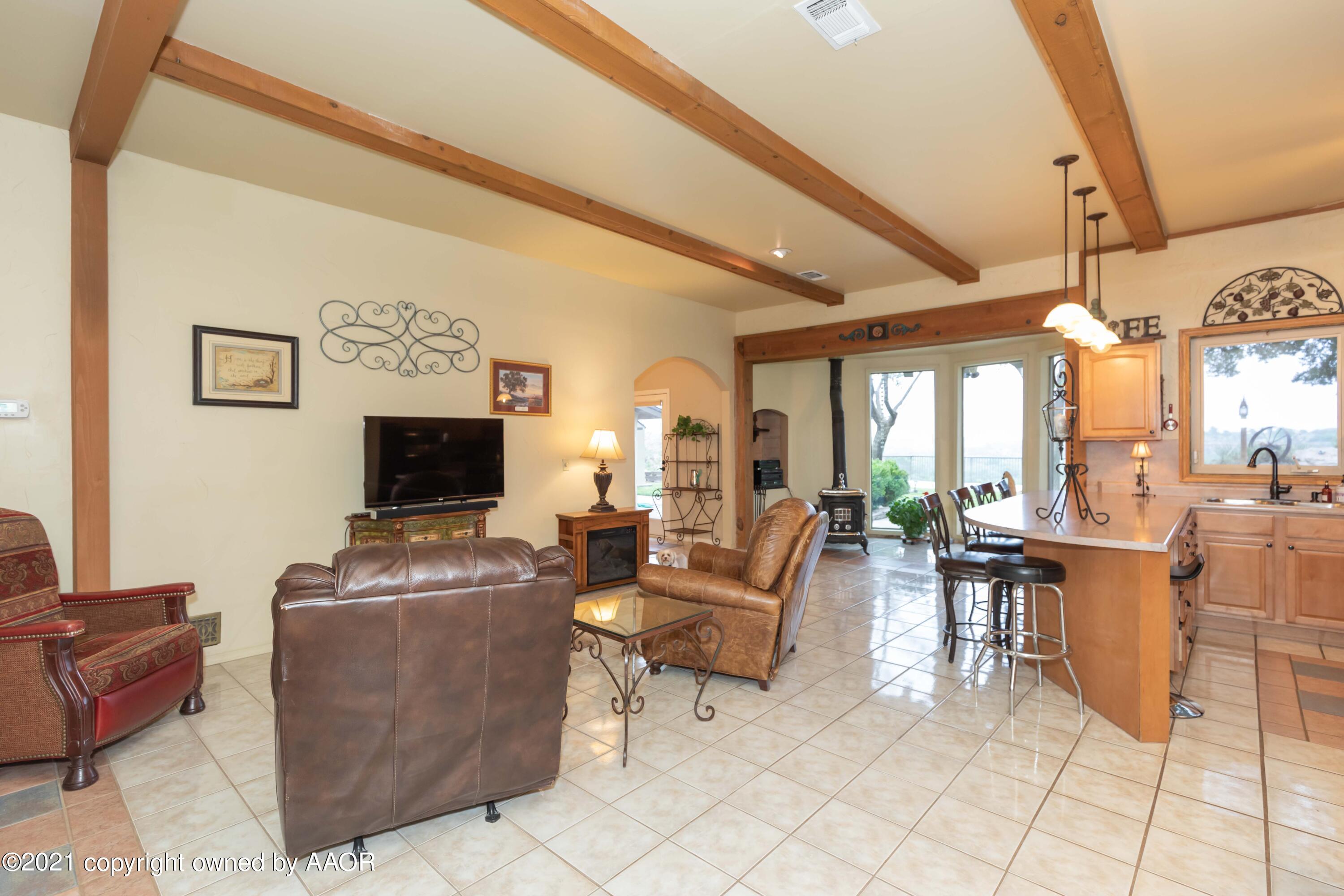 808 Craft Center Road Amarillo, TX 79118 - Photo 11 of 77 a living room with fireplace furniture and a flat screen tv