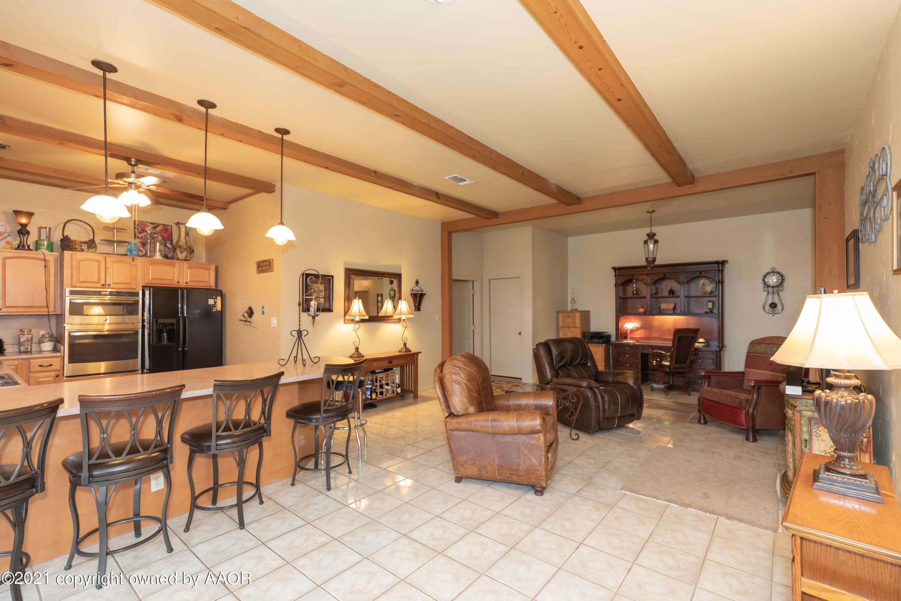 808 Craft Center Road Amarillo, TX 79118 - Photo 12 of 77 a living room with furniture a chandelier and a dining table