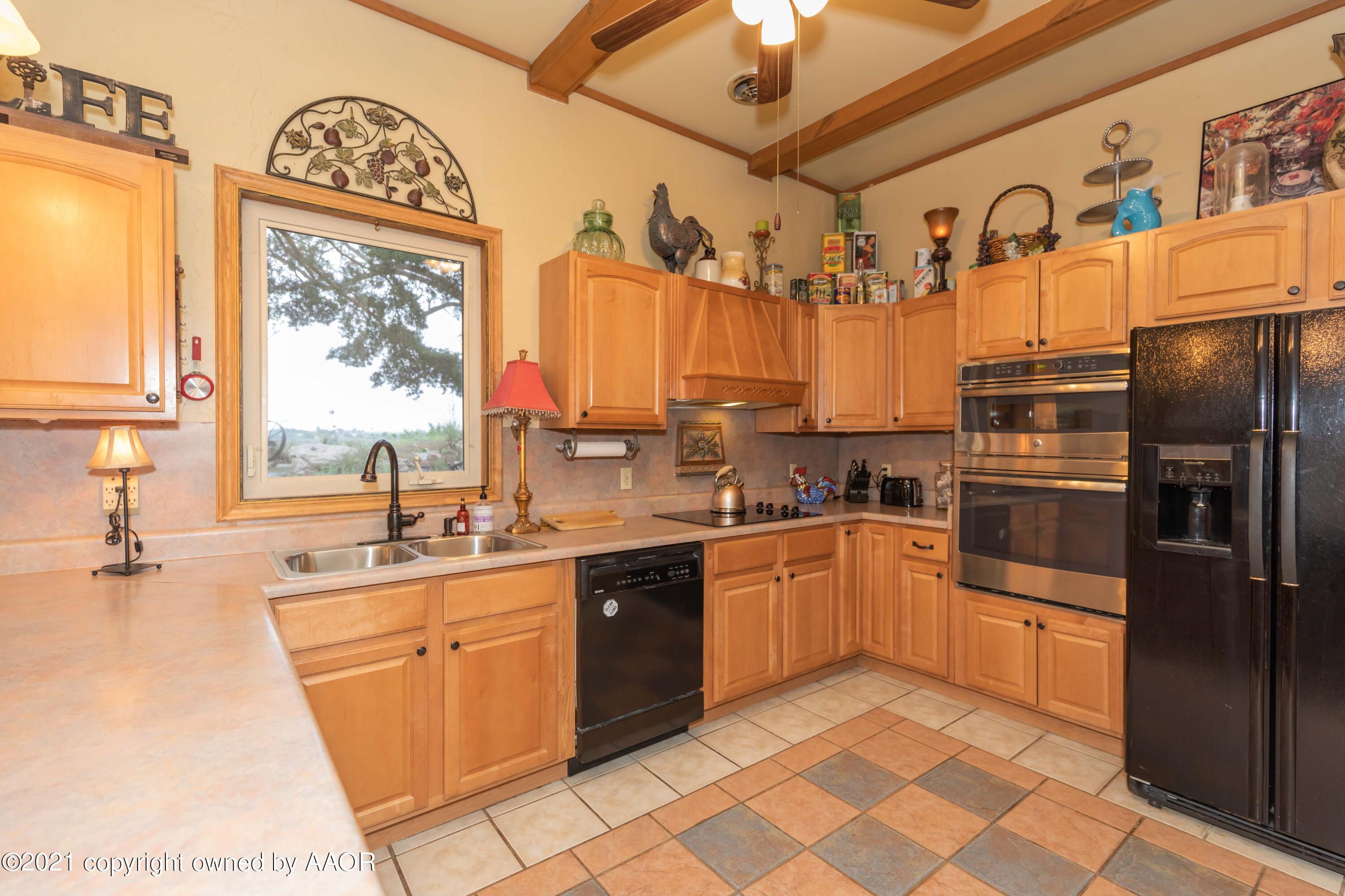 808 Craft Center Road Amarillo, TX 79118 - Photo 14 of 77 a kitchen with stainless steel appliances granite countertop a sink a stove a refrigerator and a window