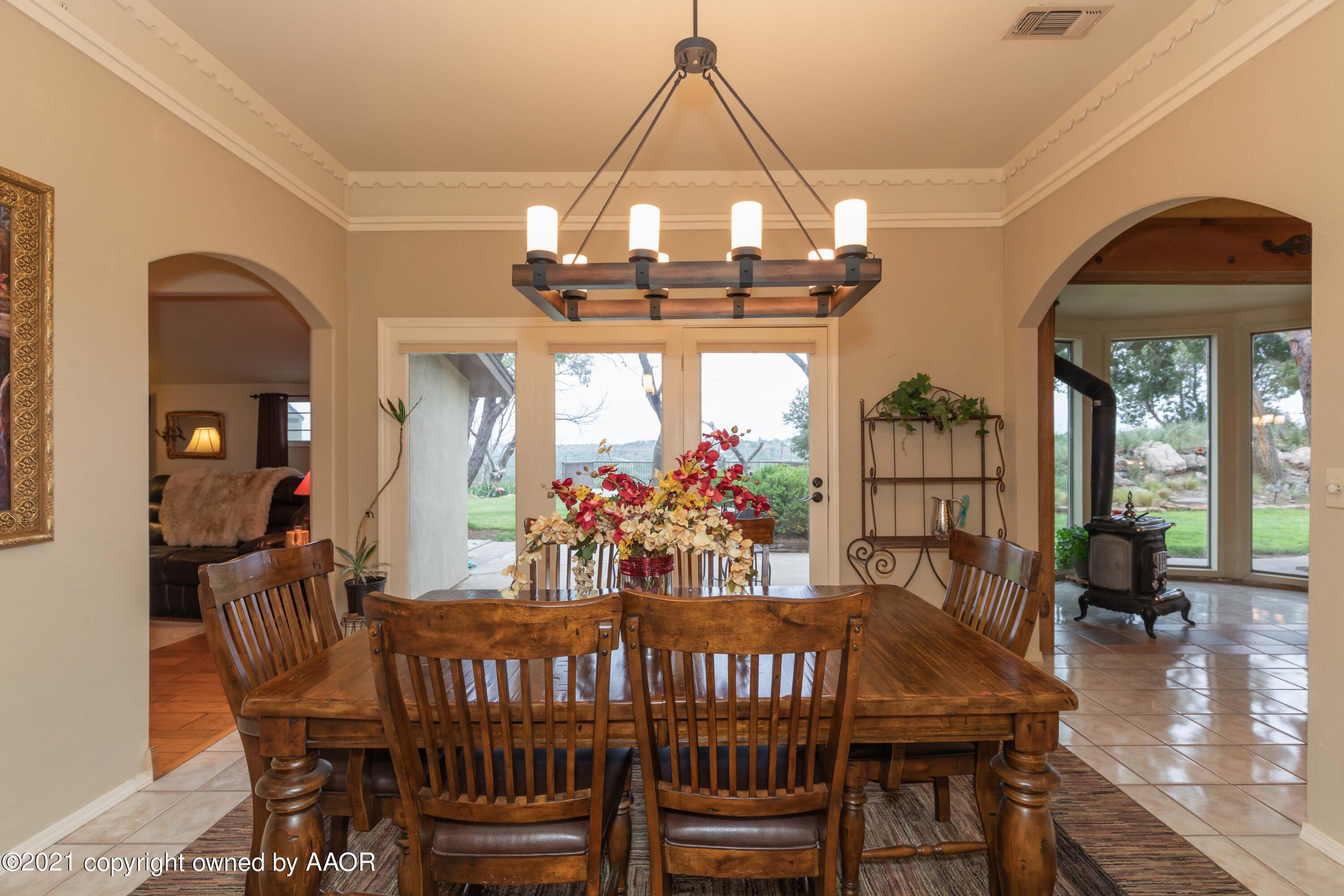 808 Craft Center Road Amarillo, TX 79118 - Photo 21 of 77 a view of a dining room with furniture a chandelier and wooden floor