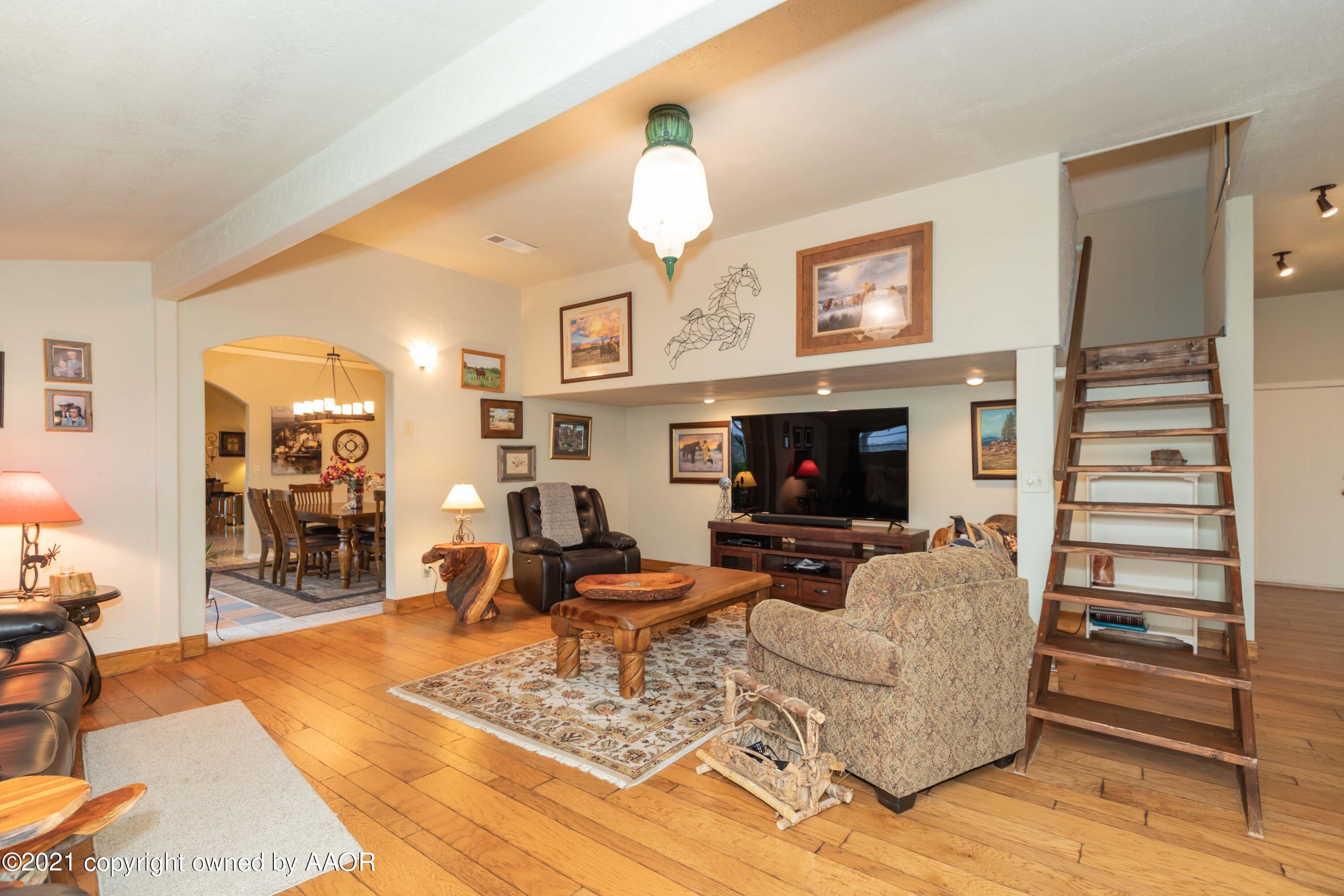 808 Craft Center Road Amarillo, TX 79118 - Photo 25 of 77 a living room with furniture a flat screen tv and a fireplace