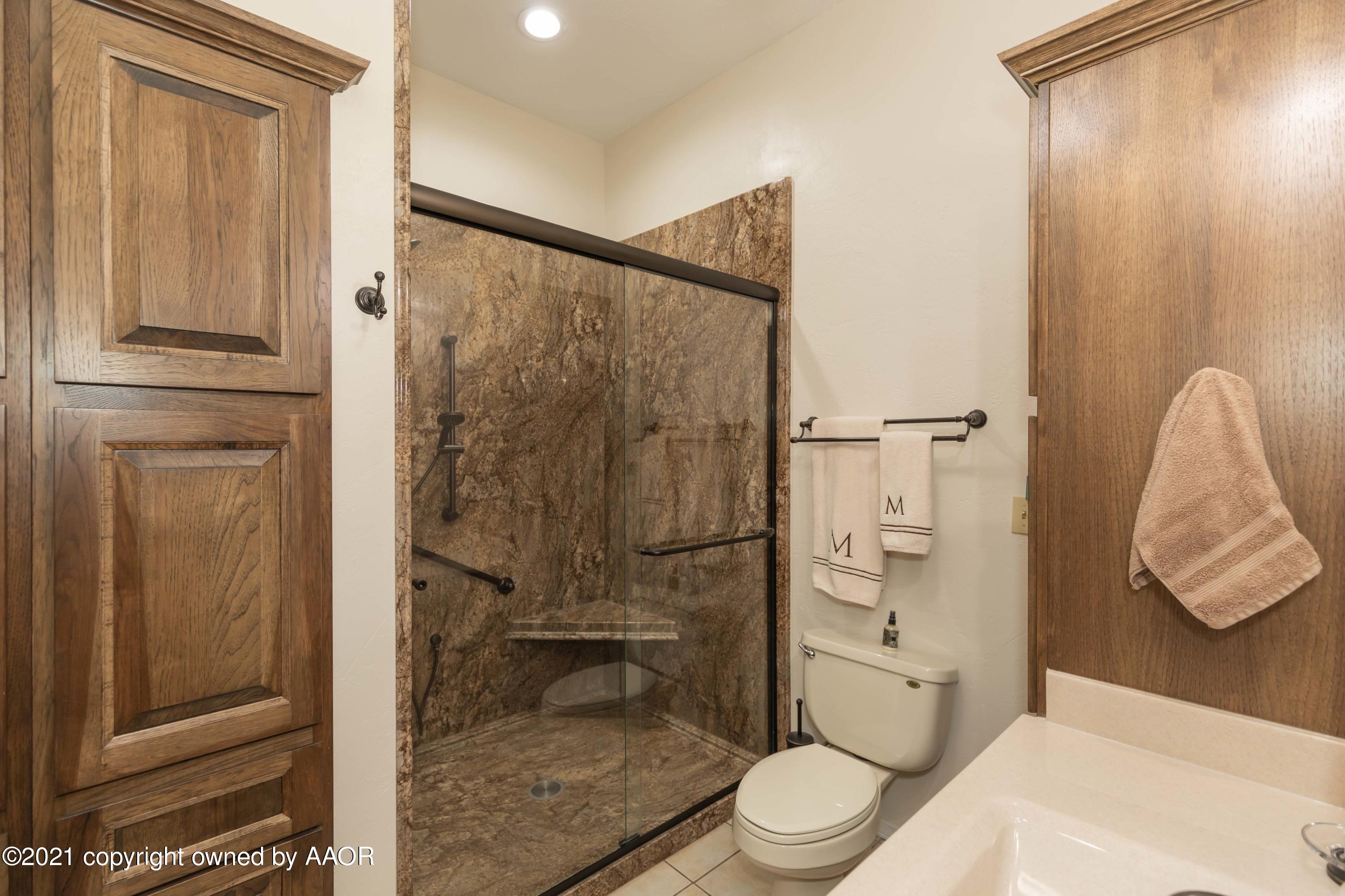 808 Craft Center Road Amarillo, TX 79118 - Photo 30 of 77 a bathroom with a toilet and a shower