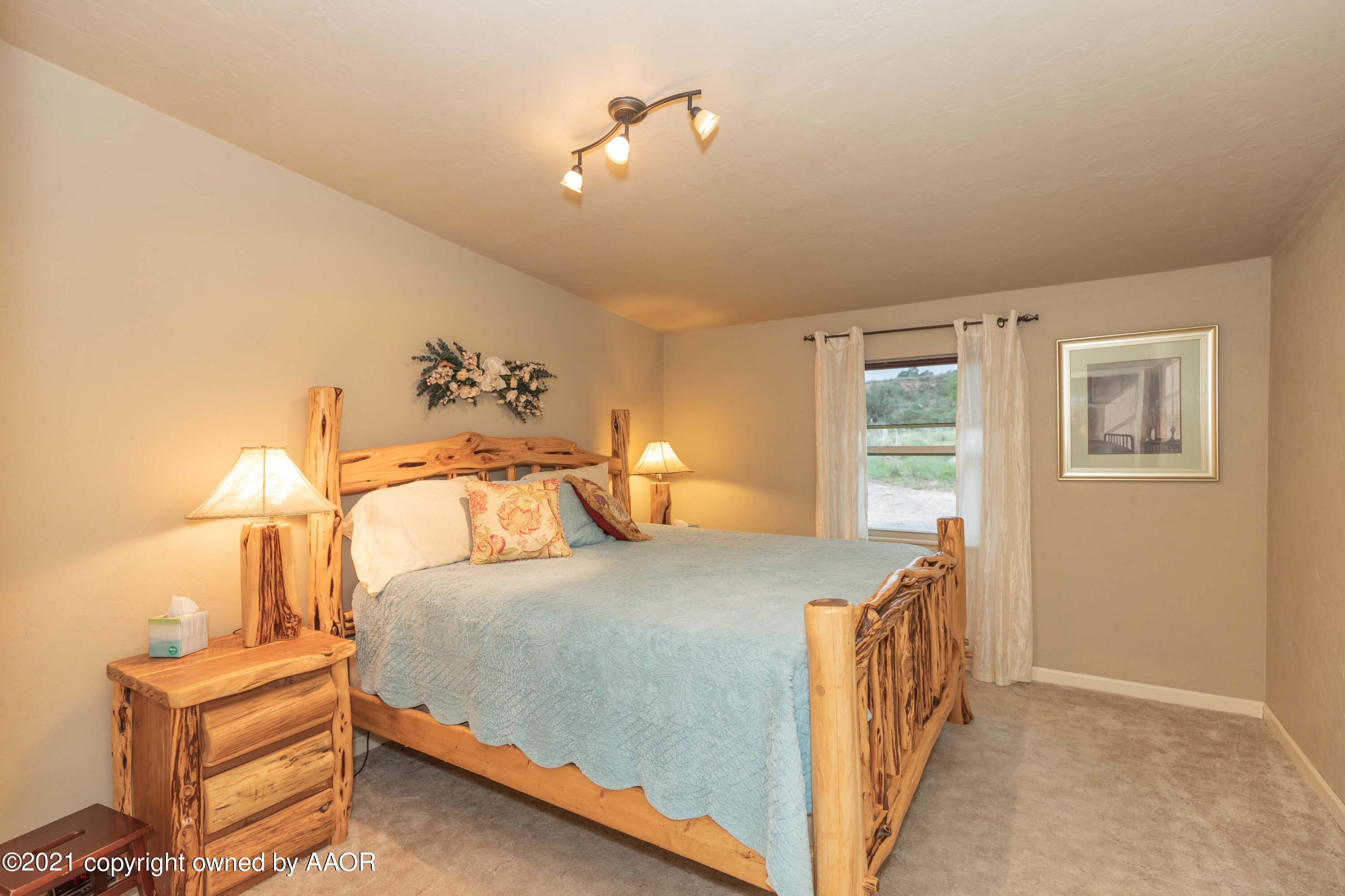 808 Craft Center Road Amarillo, TX 79118 - Photo 34 of 77 a bedroom with a bed and a lamp
