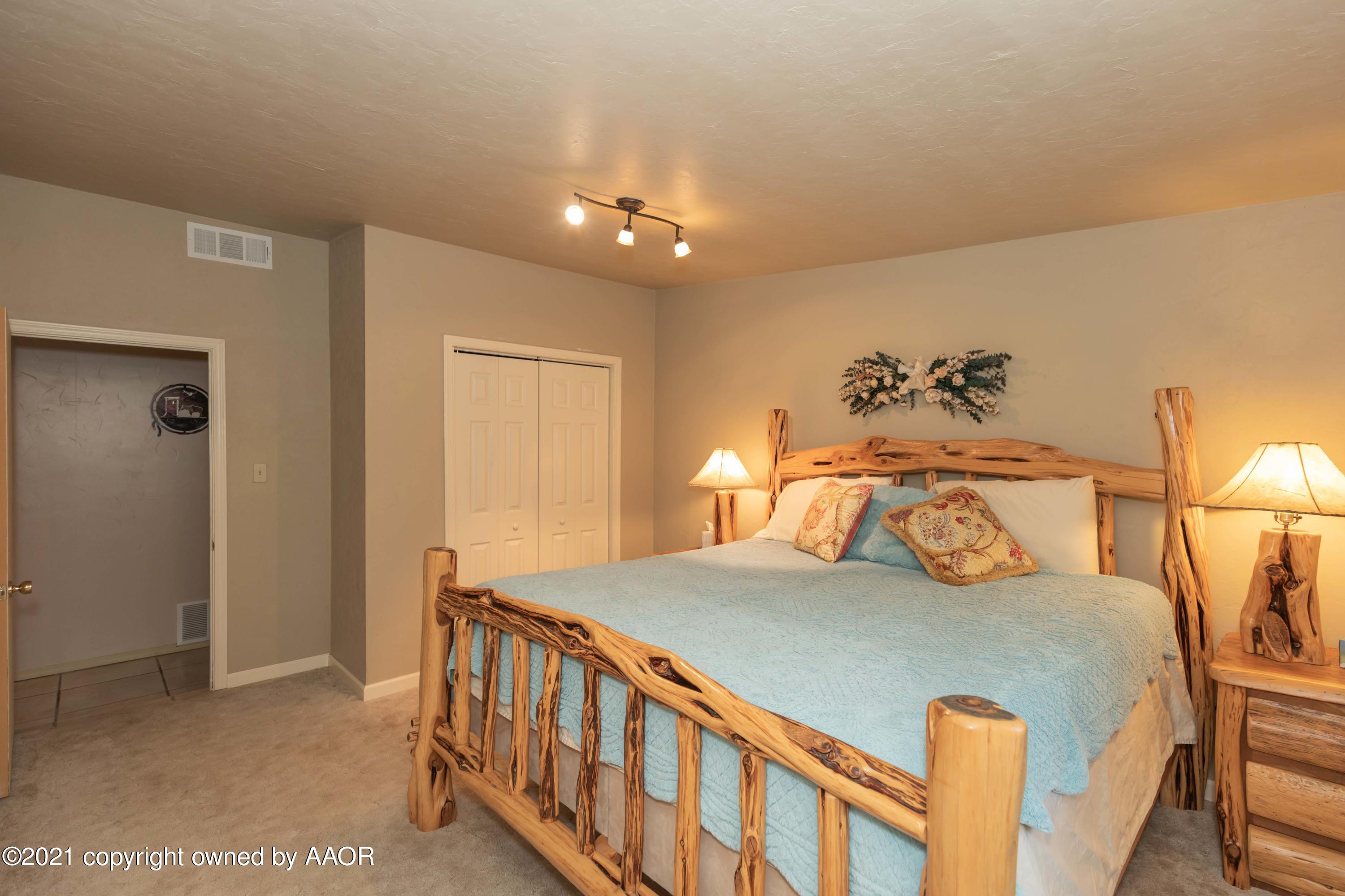 808 Craft Center Road Amarillo, TX 79118 - Photo 36 of 77 a bedroom with a bed and a potted plant