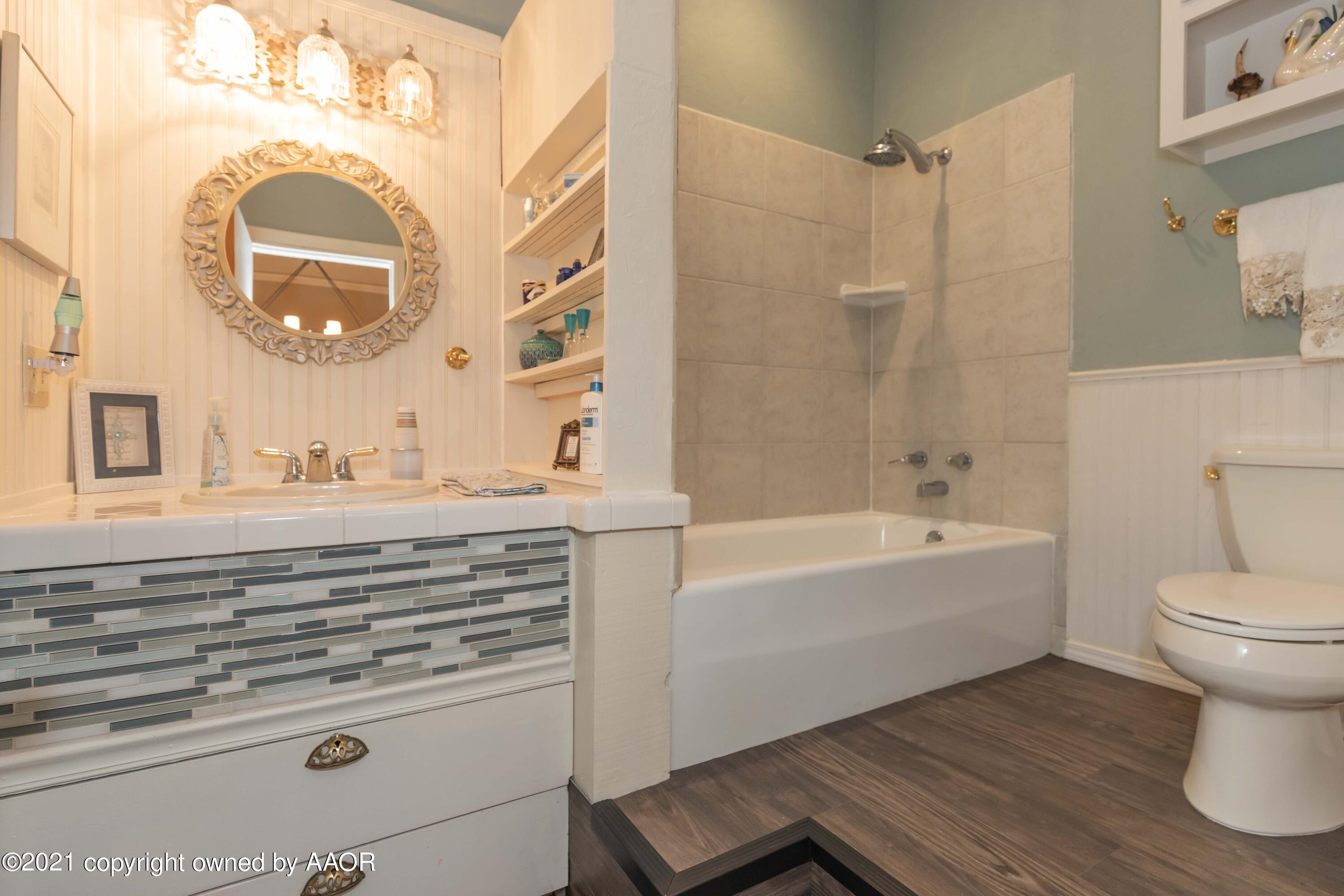 808 Craft Center Road Amarillo, TX 79118 - Photo 37 of 77 a bathroom with a sink and a mirror