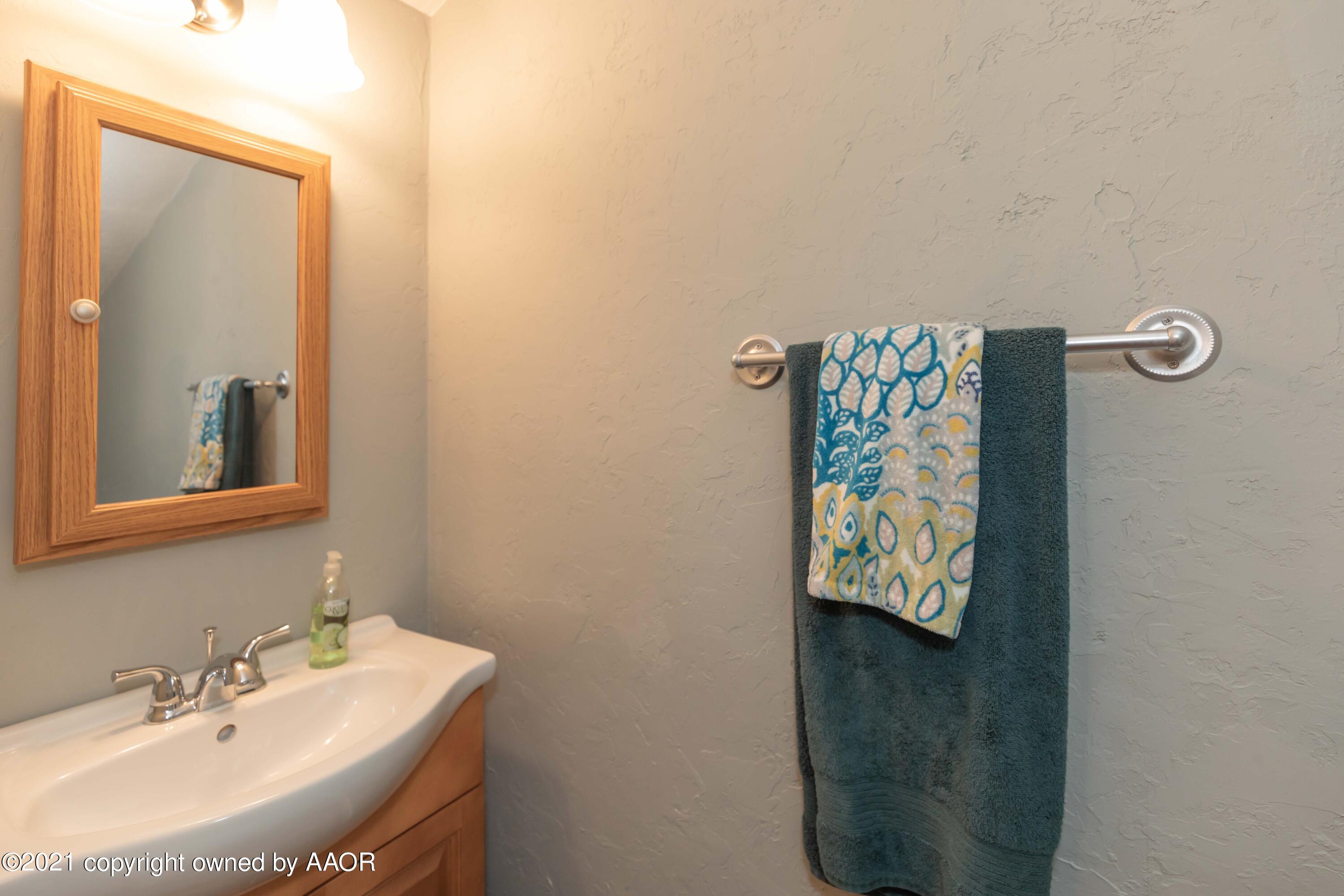 808 Craft Center Road Amarillo, TX 79118 - Photo 44 of 77 a bathroom with a sink mirror and vanity