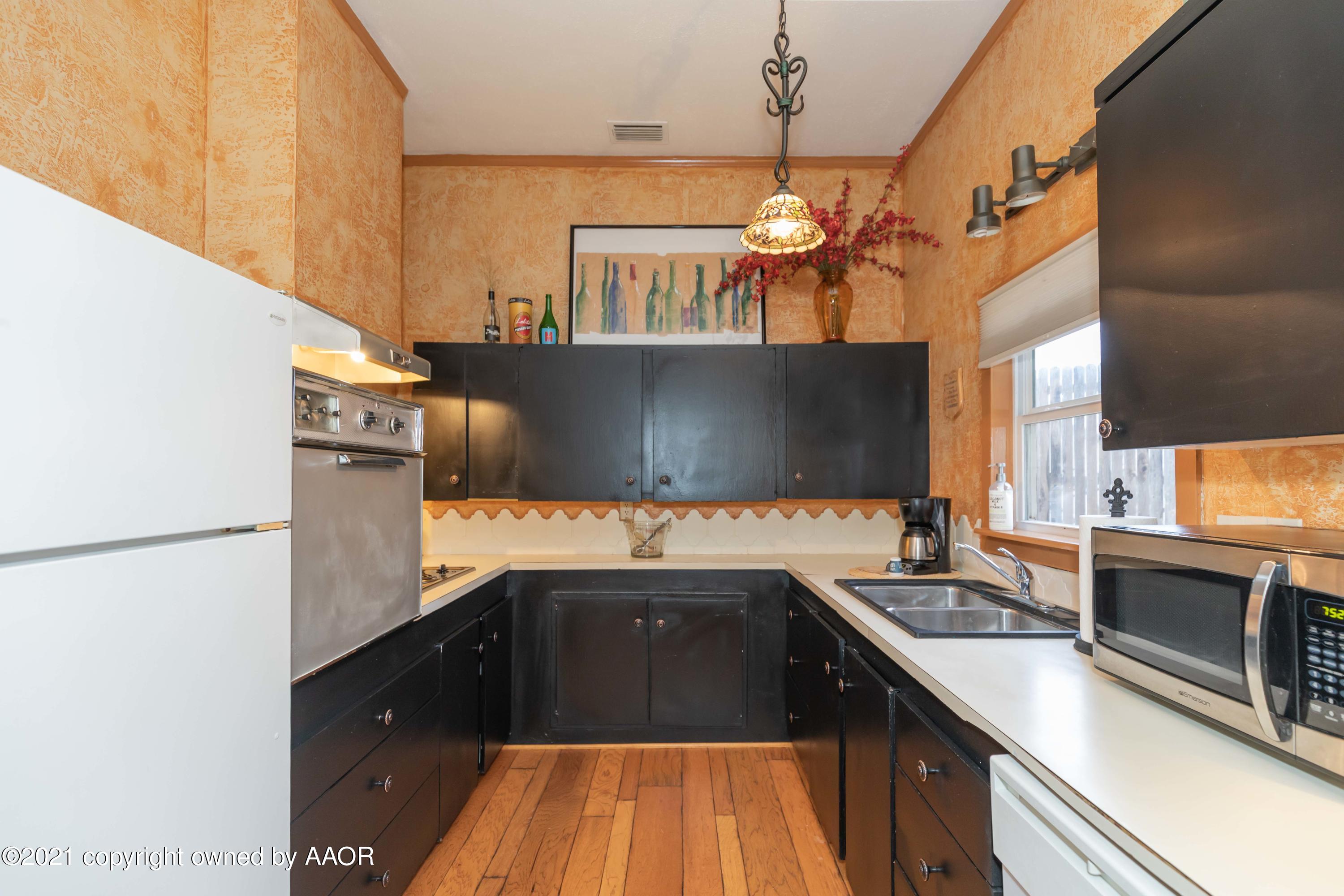 808 Craft Center Road Amarillo, TX 79118 - Photo 52 of 77 a kitchen with a sink stove and refrigerator