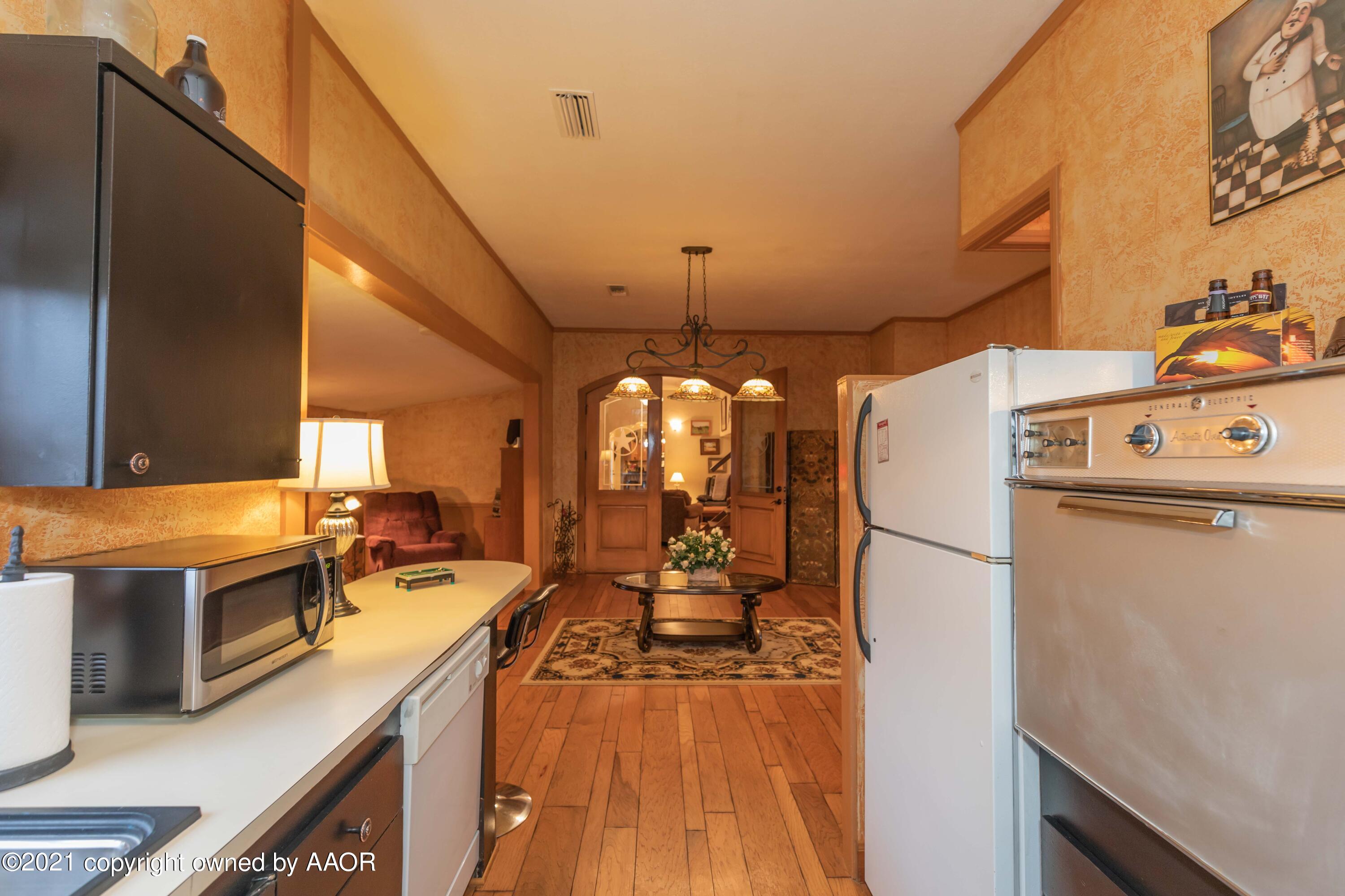 808 Craft Center Road Amarillo, TX 79118 - Photo 53 of 77 a kitchen with sink a refrigerator and wooden floor