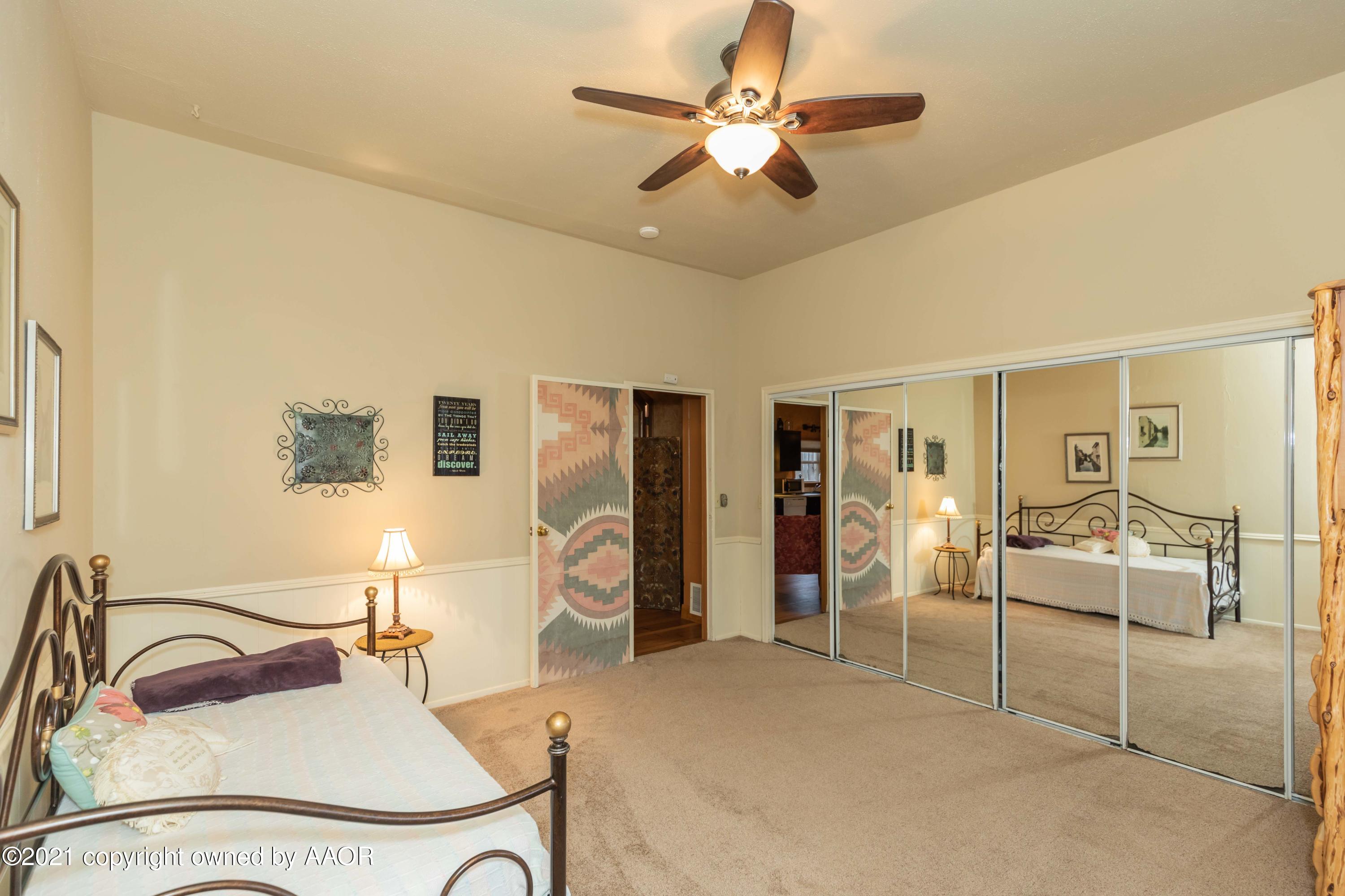 808 Craft Center Road Amarillo, TX 79118 - Photo 56 of 77 a bedroom with furniture and a large mirror