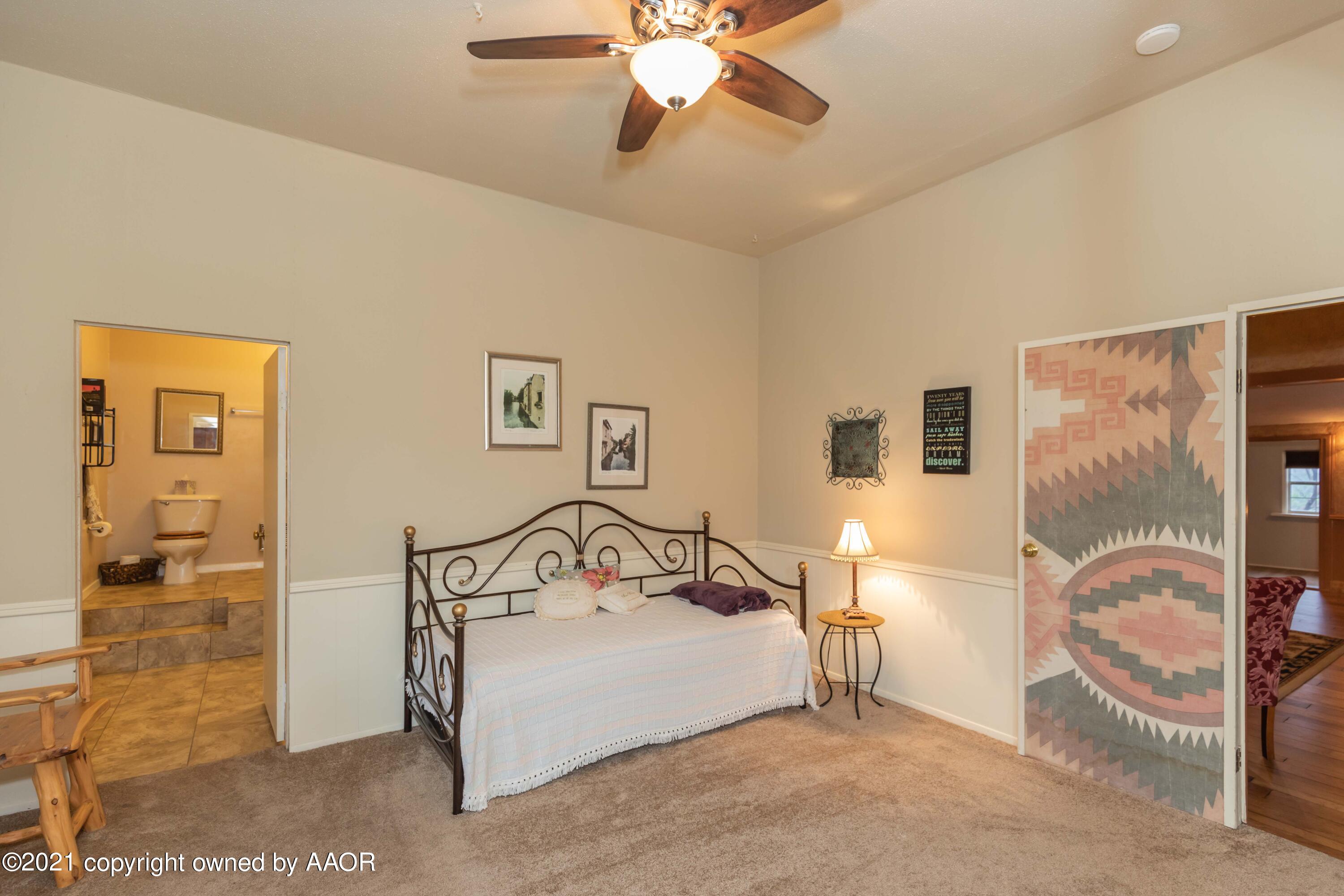 808 Craft Center Road Amarillo, TX 79118 - Photo 57 of 77 a bedroom with a bed and a mirror